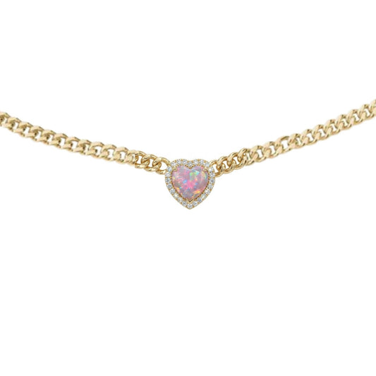 Gold necklace with a heart-shaped pink gemstone on a white background