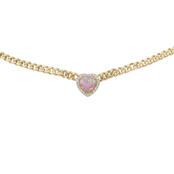 Gold necklace with a heart-shaped pink gemstone on a white background