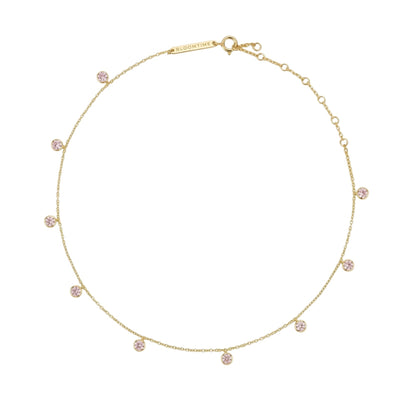 A delicate gold chain necklace with multiple small, round pink gemstone clusters spaced evenly along the chain, displayed on a clean white background.
