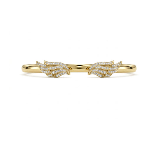 A delicate gold ring featuring two wing-shaped pavé settings, each adorned with small clear stones, shown against a plain white background.