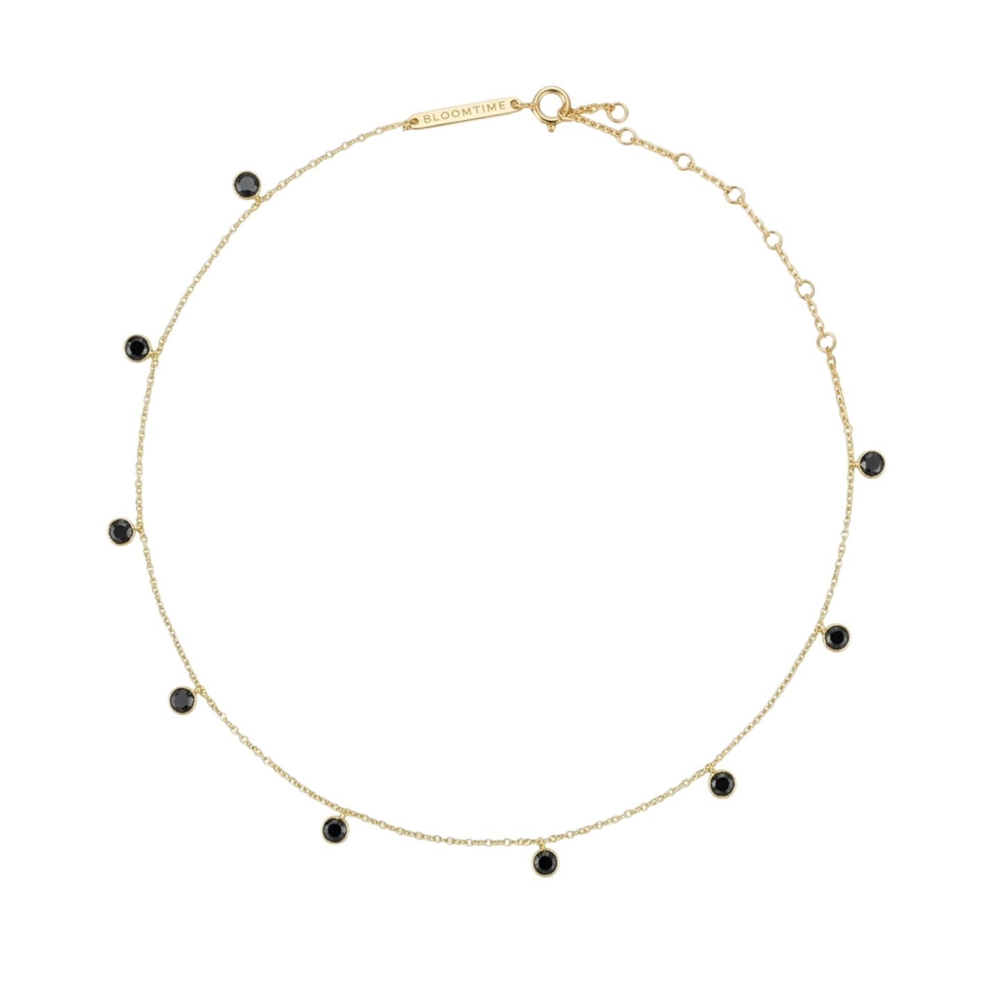 A delicate gold chain necklace with small, evenly spaced round black gemstone beads, displayed on a clean white background.