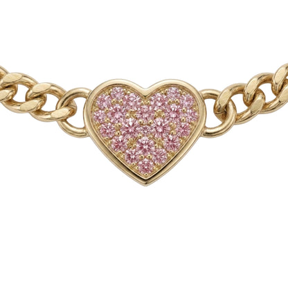A gold chain bracelet featuring a heart-shaped pavé charm set with pink stones, shown against a plain white background.