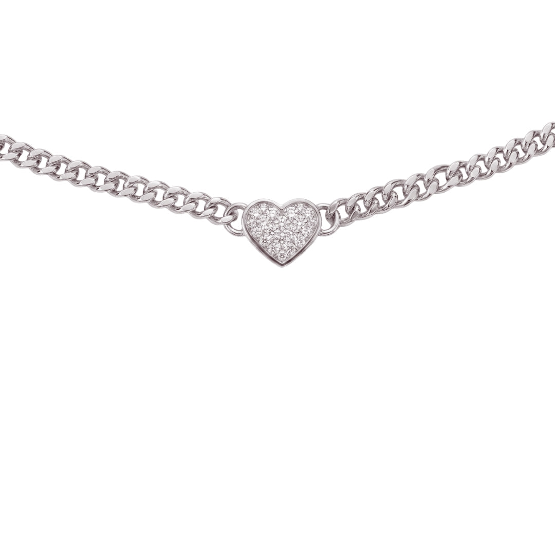 A silver chain necklace featuring a small pavé-set heart charm, shown against a plain white background.