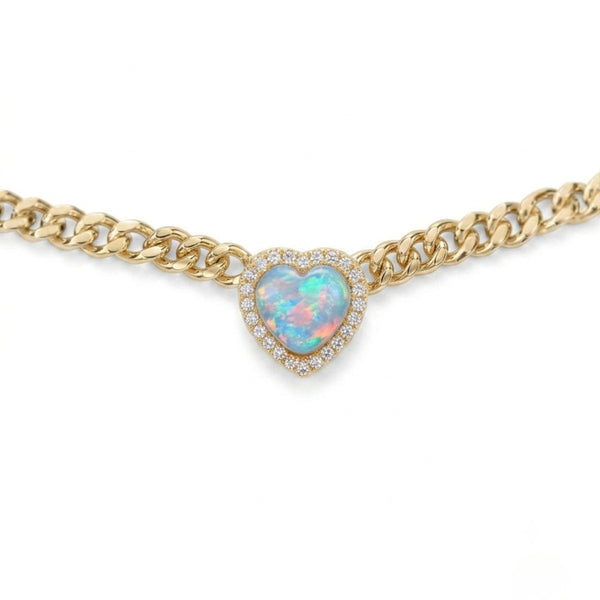 A gold chain necklace featuring a heart-shaped opal pendant surrounded by a halo of small clear stones, shown against a plain white background.