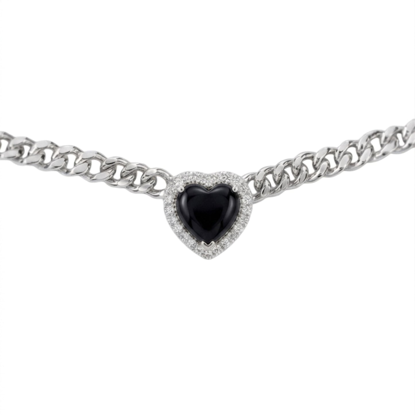 A silver-toned curb chain bracelet featuring a heart-shaped black gemstone surrounded by a halo of small clear stones, set against a plain white background.