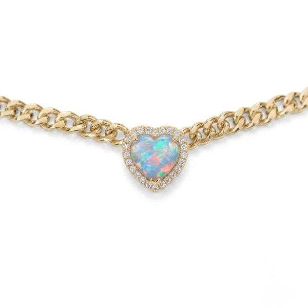 Gold chain necklace with a heart-shaped opal pendant on a white background