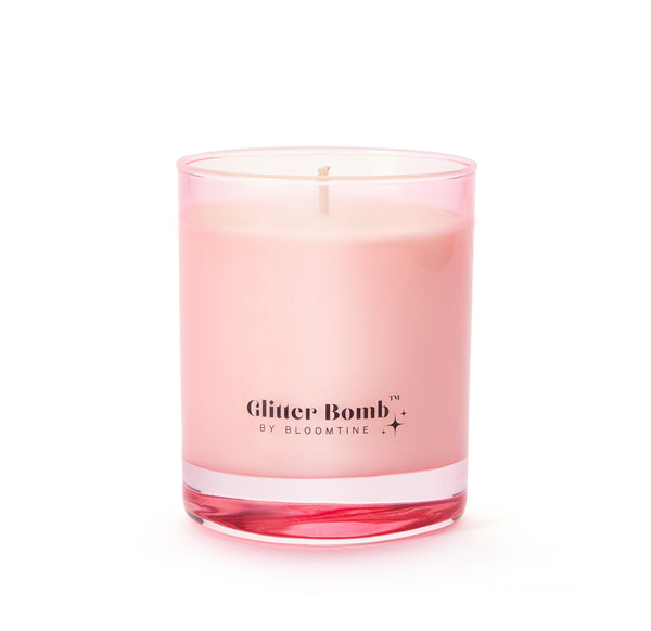 Milky Way | Glitter Bomb™ Luxury Gift Candle In Coconut, Citrus & Vanilla 230G image 0. The BLOOMTINE Glitter Bomb™ Gift Candle in a signature pink glass jar. This 30cl natural soy wax candle features a tropical coconut and lime scent and reveals a hidden iridescent 'Sparkle Pool' within the first hour of burning, creating a mesmerizing shimmer effect
