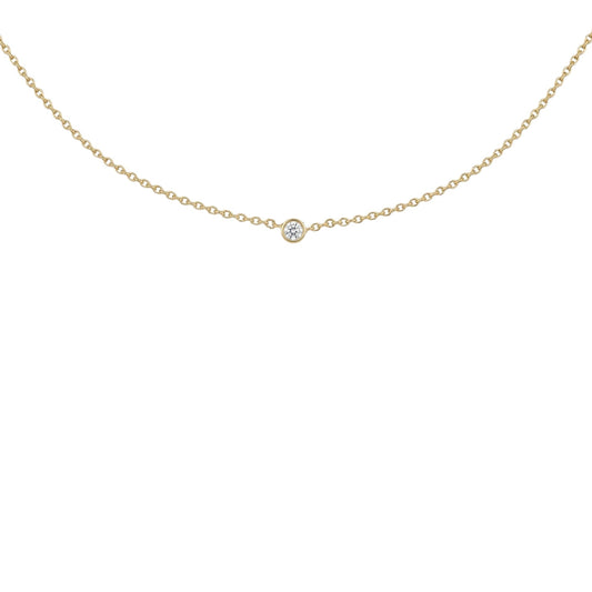 A delicate gold chain necklace with a single small round clear gemstone pendant, displayed against a solid white background.