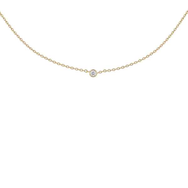 A delicate gold chain necklace with a single small round clear gemstone pendant, displayed against a solid white background.