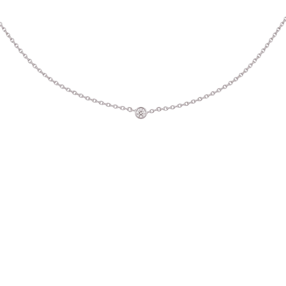A delicate silver chain necklace with a single small round-cut gemstone at the center, displayed against a solid white background.