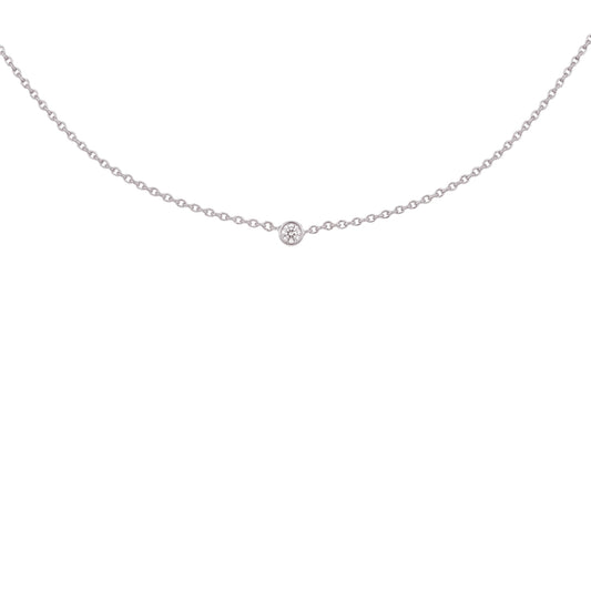A delicate silver chain necklace with a single small round-cut gemstone at the center, displayed against a solid white background.