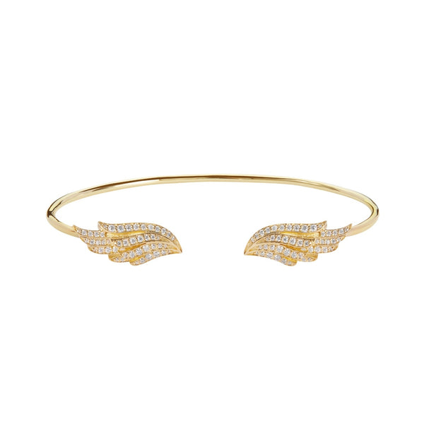 The BLOOMTINE Illuminess™ Angel Wing Bangle in Gold Vermeil. Featuring two intricately carved wings studded with shimmering lab-grown moissanites, this protective talisman bracelet represents the 'Extraordinary Human' spirit in a high-luster gold finish