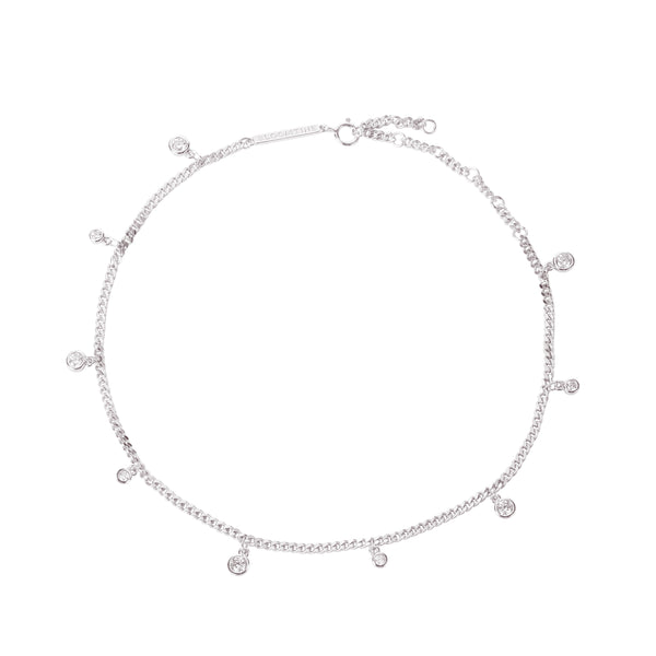 Sterling silver droplet anklet with rhodium coating, featuring multiple round-cut lab diamonds. The jewelry is shown on a woman's foot from a side-profile angle, highlighting the delicate 'Apah Water Goddess' design and the brilliant refraction of the stones