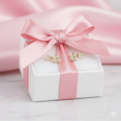 Bloomtine-luxury-jewellery-gift-box. A professional-shot of a white-gift-box with a satin-pink-ribbon and hand-tied-bow, presented-on-a-textured-pink-fabric-background. This premium-packaging is designed-for-gifting Bloomtine-gold-vermeil-flower-stud-earrings, creating a beautiful-unboxing-experience. The image-highlights our signature-packaging-style, perfect-for-birthdays, anniversaries-or-special-occasions.