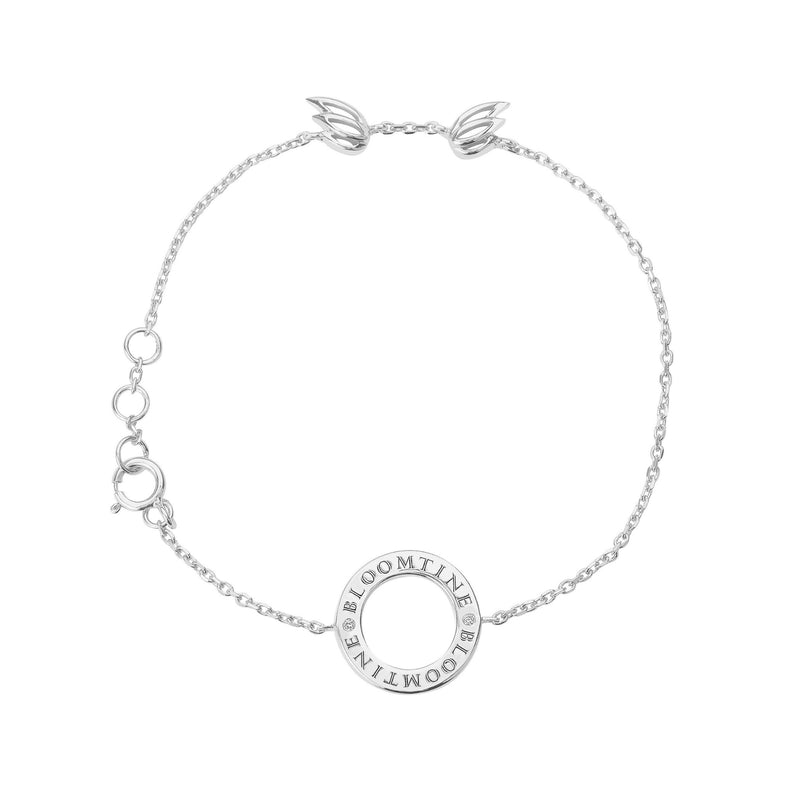 "BLOOMTINE Mini Halo Wings™ gold bracelet on a neutral background. This symbolic talisman features a lab-moissanite halo and dual-wing design in sterling silver, representing grace and spiritual protection for the extraordinary human