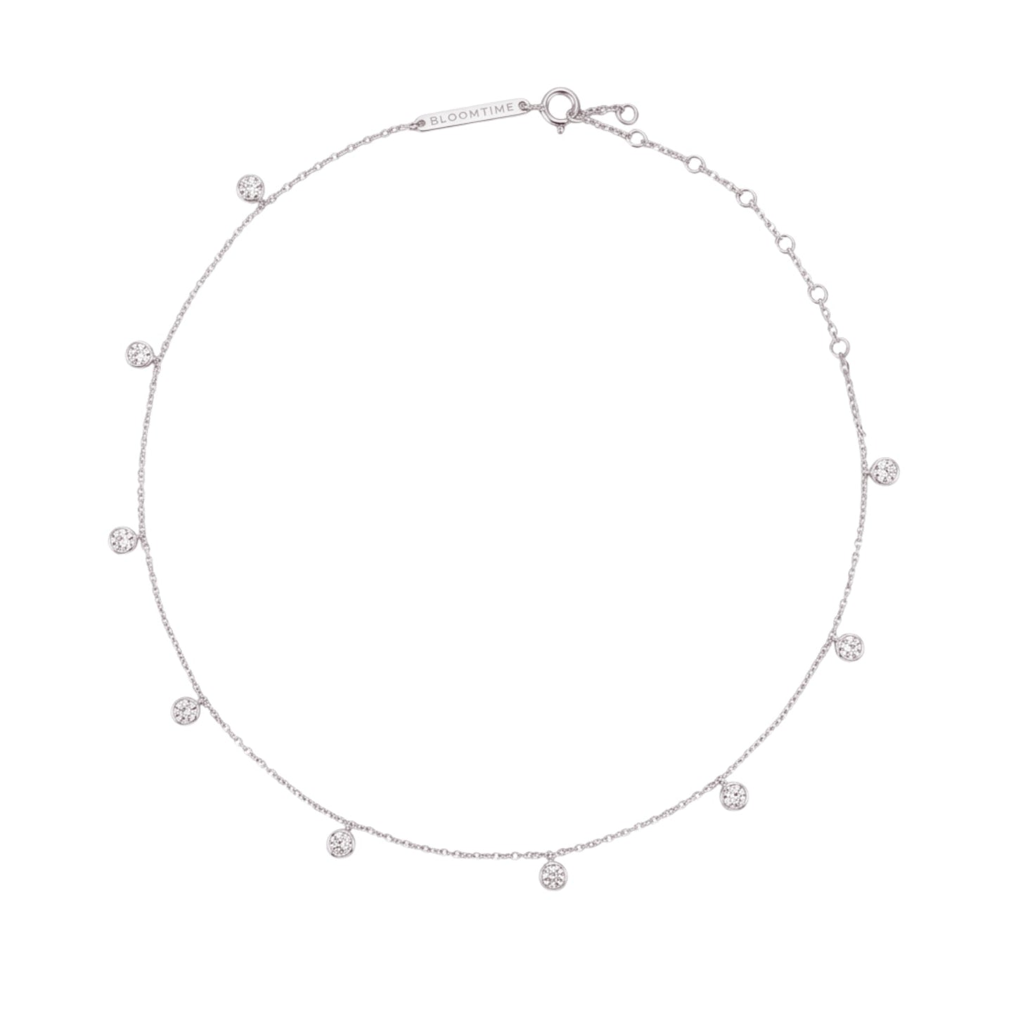 A delicate silver chain necklace with multiple small, evenly spaced round clear gemstone charms, displayed on a solid white background.