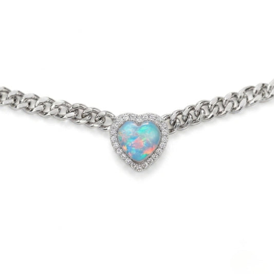 A silver-tone chain bracelet featuring a heart-shaped opal pendant with a halo of small clear stones, shown against a plain white background.
