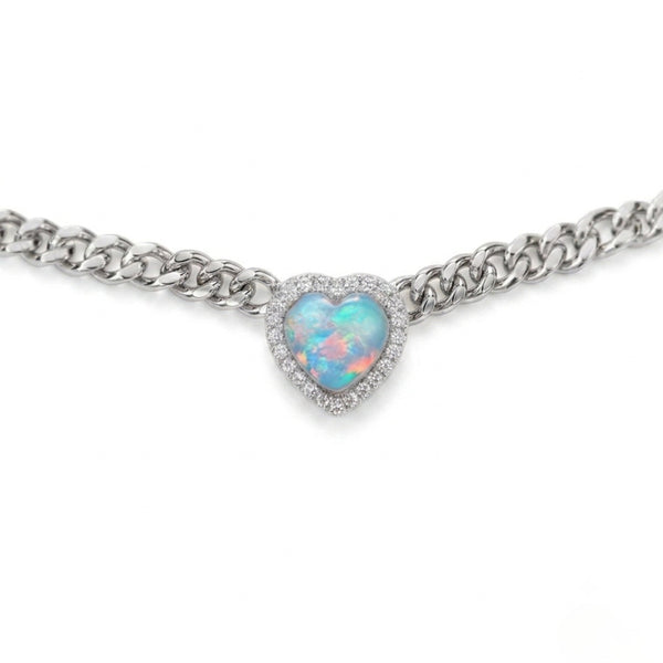 A silver-tone chain bracelet featuring a heart-shaped opal pendant with a halo of small clear stones, shown against a plain white background.