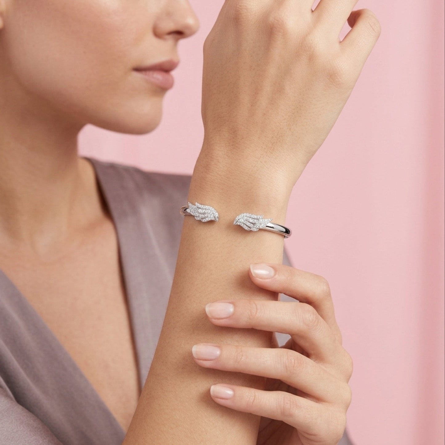 Gold heart-shaped chain bracelet featuring a central heart charm paved with small black gemstones and accented with gold dots, shown on a plain white background.