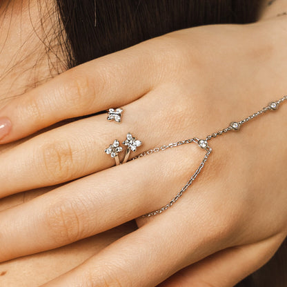 Enchanting Flutterfly™ Sterling Silver Trio Butterfly Ring image 1. A detailed-macro-close-up of the Enchanting-Flutterfly-ring, highlighting the-precision-setting of the-four-brilliant-cut-lab-grown-moissanites. The-image-captures the-mesmerizing-sparkle and high-shine-finish of the solid-sterling-silver-band. This-copyrighted-Bloomtine-design emphasizes-handmade-artistry and luxury-quality for collectors of unique-butterfly-jewellery