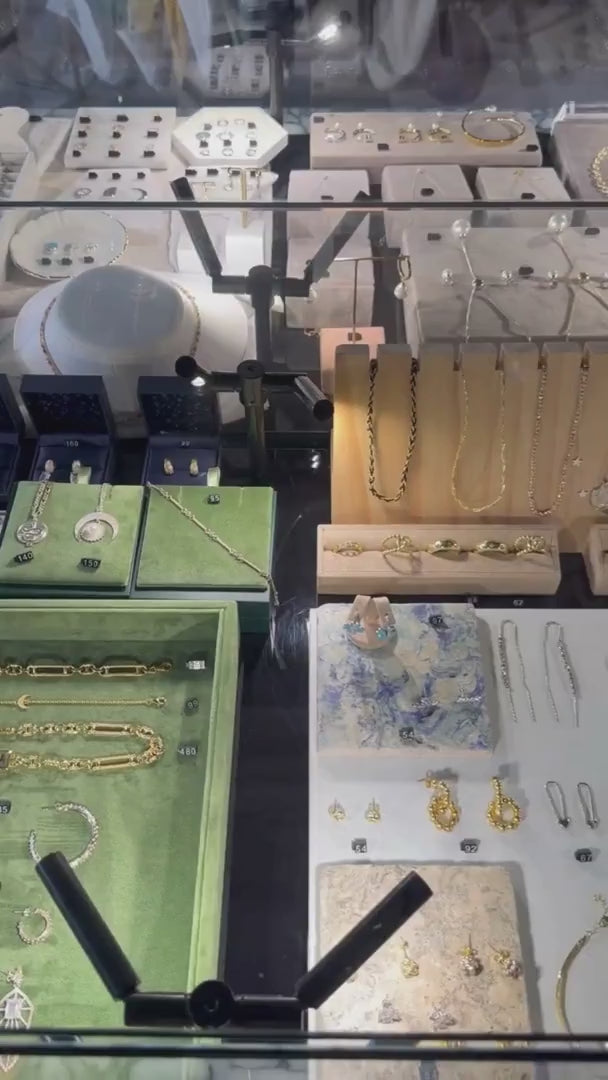 Bloomtine-Mini-Halo-Wings-sterling-silver-diamond-angel-choker. A professional-retail-shot of the full-Mini-Halo-Wings-collection on display at Wolf-and-Badger. The-image features a-dainty-choker with a-diamond-encrusted-angel-wing-pendant in 925-sterling-silver. Shown-within a-luxury-in-store-setting, this-visual highlights the-entire-angelic-jewellery-range, showcasing the-fine-craftsmanship and spiritual-symbolism that-defines the Bloomtine-brand in a-premium-boutique-environment