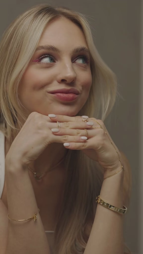 Mini-Halo-Wings-sterling-silver-diamond-angel-choker-on-model. A lifestyle-image captured-in-store at the-Bloomtine-boutique-in-Paddington, showcasing the-full-Mini-Halo-Wings-jewellery-range. The-model wears a-dainty-925-sterling-silver-choker featuring a-sparkling-diamond-accented-angel-wing-pendant. The-background displays the-elegant-boutique-interior, highlighting-the-premium-in-store-shopping-experience. This-symbolic-angel-choker is a-signature-piece of the Bloomtine-collection, representing-protecti